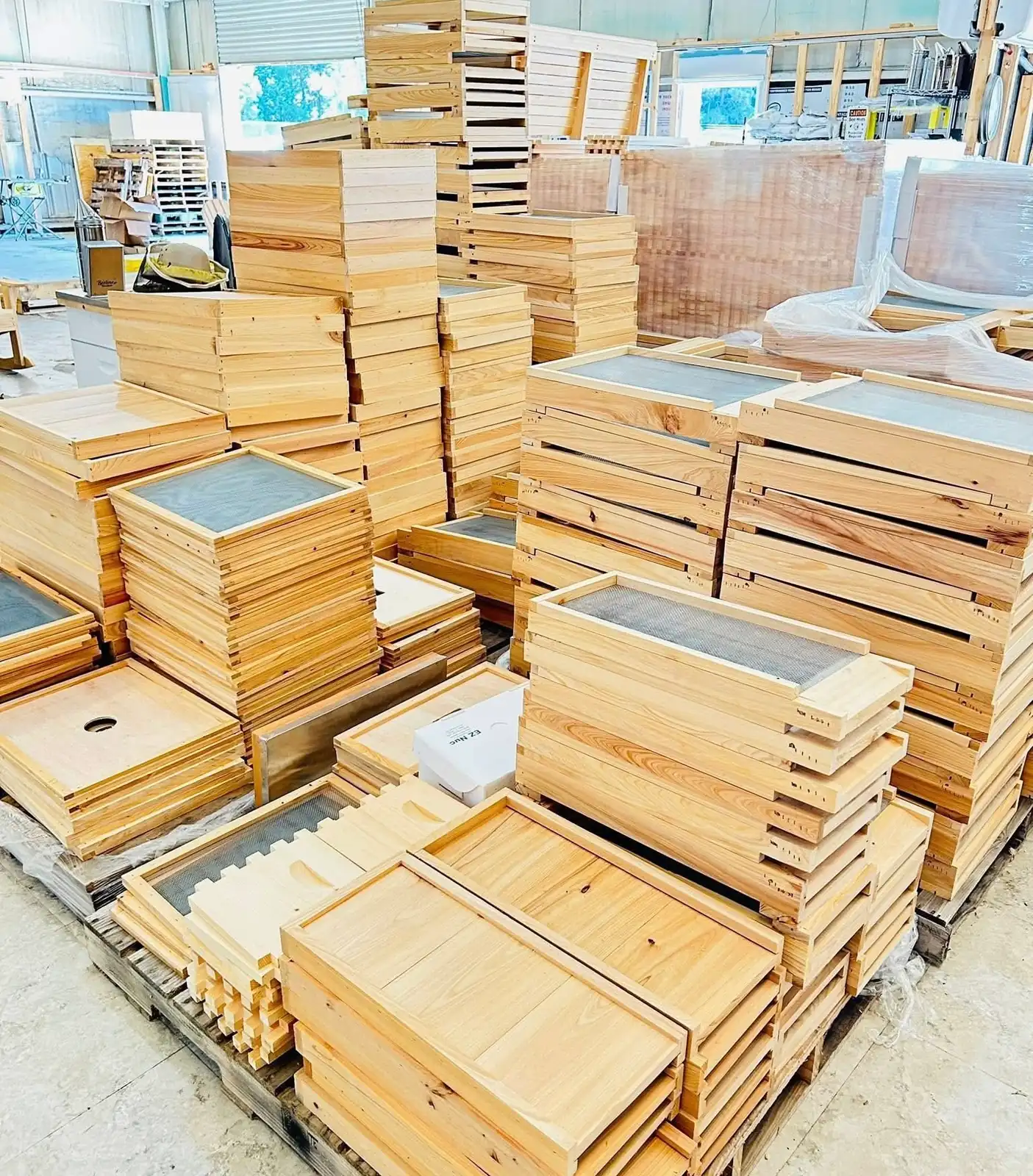 Pallets of unfinished wooden hive boxes, inner covers and frames at Overflow Honey Co.