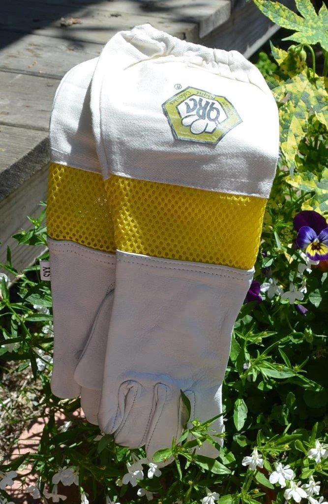 A beekeeping jacket with veil hanging outdoors