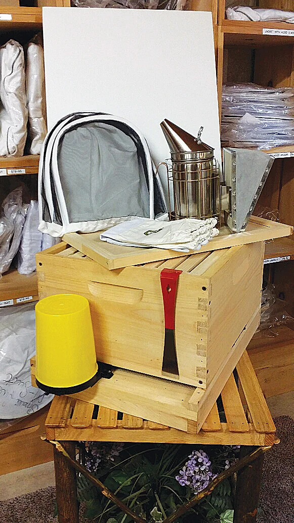 Hive equipment and a beekeeping starter set on a store shelf