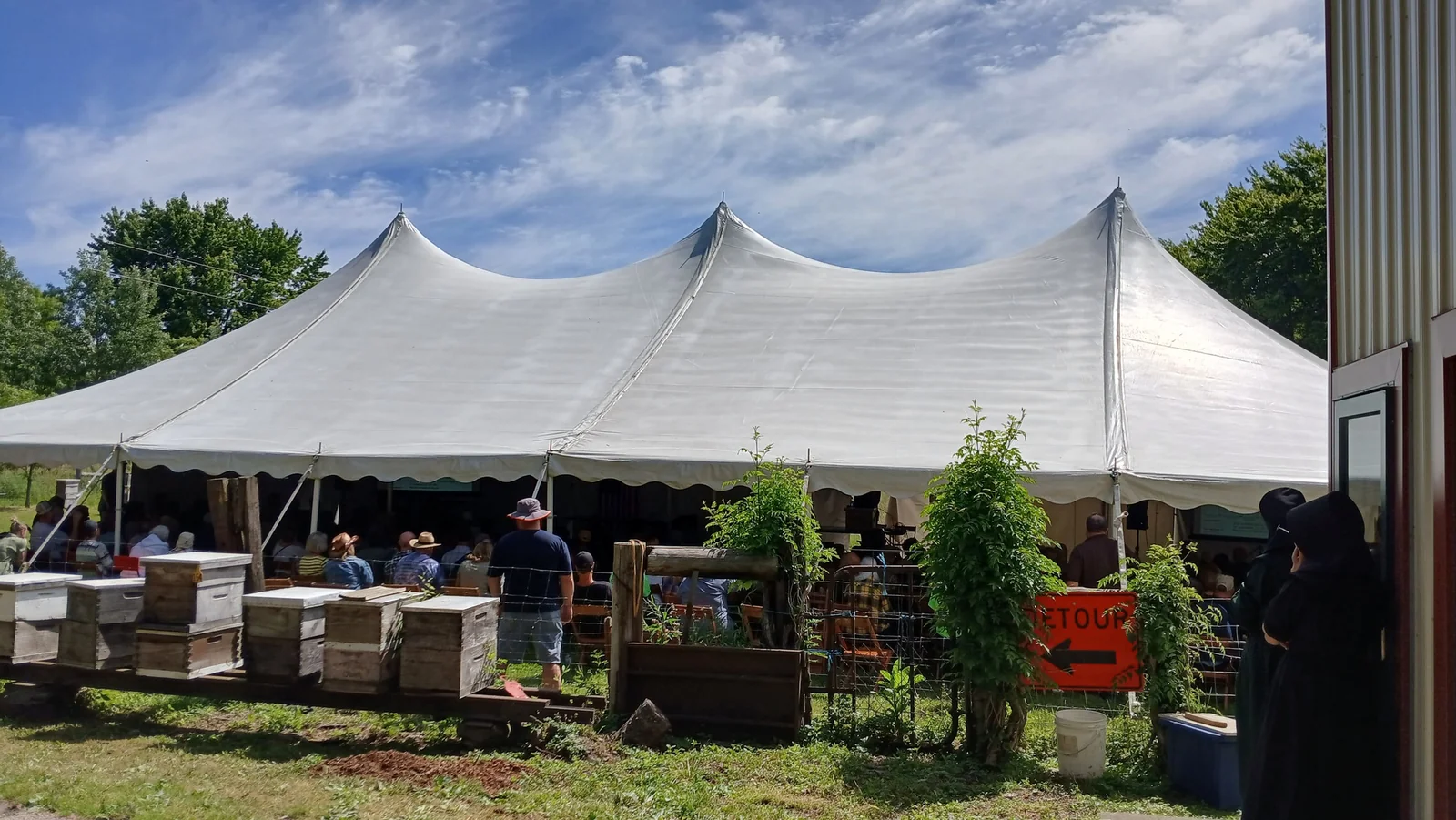 Field day tent and hives on the farm
